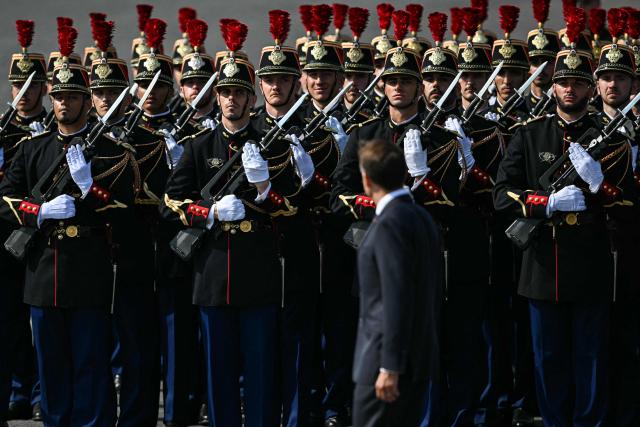 France's Prime Minister Sebastien Lecornu reviews troops during the annual Bastille Day military parade on the Champs-Elysees Avenue in Paris on July 14, 2026. (Photo by LOU BENOIST / AFP)