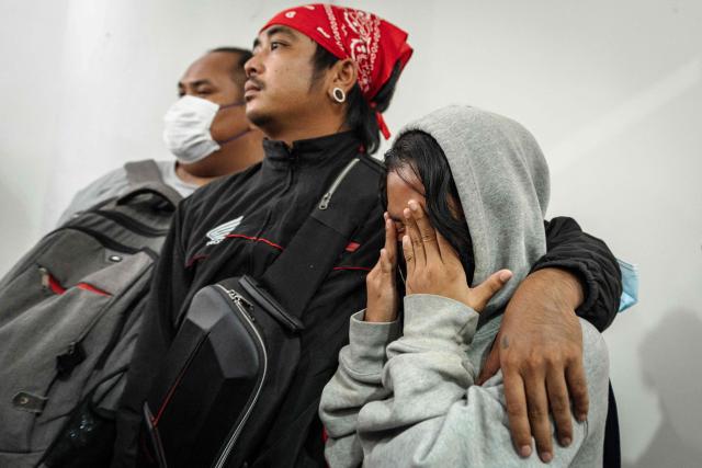 Relatives mourn victims killed in a bar fire at the Police General Hospital in Bangkok on July 14, 2026. Grieving relatives of the victims of a huge Bangkok bar fire claimed their bodies on July 14 as the death toll rose to 30, even as others held out hope that missing loved ones were alive. (Photo by chanakarn LAOSARAKHAM / AFP)