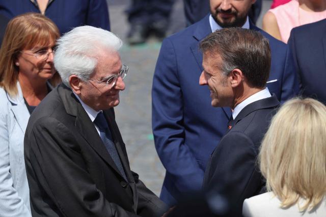 France's President Emmanuel Macron (R) greets Italy's President Sergio Mattarella during the annual Bastille Day military parade on the Champs-Elysees Avenue in Paris on July 14, 2026. (Photo by Ludovic MARIN / AFP)