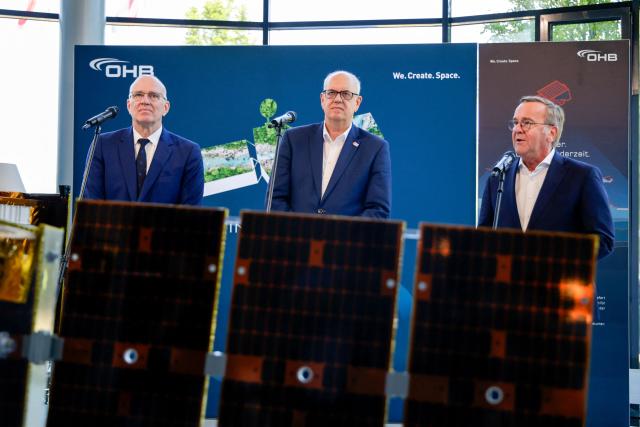(L-R) Marco Fuchs, CEO of the OHB group, Andreas Bovenschulte, President of the Senate and Mayor of Bremen, and German Defence Minister Boris Pistorius speaks give a press briefing at the headquarters of German aerospace and technology company OHB in Bremen, northwestern Germany, on July 14, 2026. Pistorius visited OHB during his summer tour throughout Germany. According to the group, it covers "the entire spectrum of modern space technologies", with activities ranging "from the development of complete satellite systems and space missions to infrastructure for access to space, as well as data-driven applications and digital services". (Photo by FOCKE STRANGMANN / AFP)