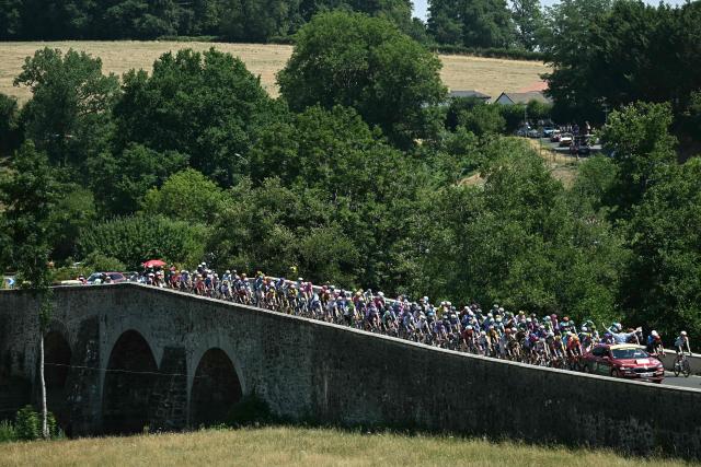 Tour de France director Christian Prudhomme gestures from atop his race direction vehicle to give the start to the pack of riders (peloton) at the start of the 10th stage of the 113th edition of the Tour de France cycling race, 166,6 km between Aurillac and Le Lioran in the Massif Central, on July 14, 2026. (Photo by Loic VENANCE / AFP)
