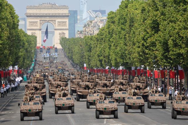 France's Armed Forces drive their motorised vehicles during the annual Bastille Day military parade on the Champs-Elysees Avenue in Paris on July 14, 2026. (Photo by Ludovic MARIN / AFP)