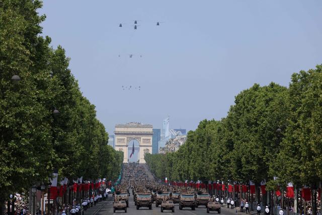 France's Armed Forces drive Light armoured vehicles (VBL) vehicles (front) and VBMR Griffon multirole armoured vehicles during the annual Bastille Day military parade on the Champs-Elysees Avenue  in front of the Arc de Triomphe in Paris on July 14, 2026. (Photo by Ludovic MARIN / AFP)