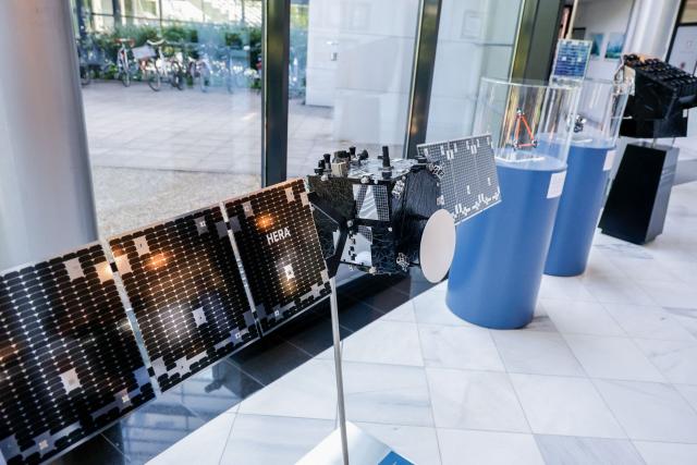 A models satellites are displayed in the entrance hall of German aerospace and technology company OHB is pictured at their headquarters in Bremen, northwestern Germany, on July 14, 2026. The German Defence Minister visited OHB during his summer tour throughout Germany. According to the group, it covers "the entire spectrum of modern space technologies", with activities ranging "from the development of complete satellite systems and space missions to infrastructure for access to space, as well as data-driven applications and digital services". (Photo by FOCKE STRANGMANN / AFP)