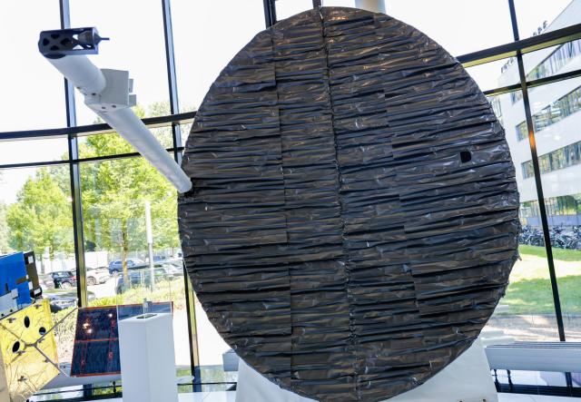 A model of a satellite is displayed in the entrance hall of German aerospace and technology company OHB is pictured at their headquarters in Bremen, northwestern Germany, on July 14, 2026. The German Defence Minister visited OHB during his summer tour throughout Germany. According to the group, it covers "the entire spectrum of modern space technologies", with activities ranging "from the development of complete satellite systems and space missions to infrastructure for access to space, as well as data-driven applications and digital services". (Photo by FOCKE STRANGMANN / AFP)
