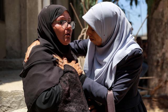 EDITORS NOTE: Graphic content / Women react during the funeral for several victims killed after a police station was was hit by Israeli bombardment in the Jabalia camp for Palestinian refugees in the northern Gaza Strip, in Gaza City on July 14, 2026. Gaza's civil defence agency and the hospital said that the Israeli airstrike on the police station in northern Gaza killed eight people on July 14, including a woman officer. In a statement condemning the strike, Palestinian Islamist movement Hamas, which controls Gaza's police force, said that the police station chief was among those killed. (Photo by Omar AL-QATTAA / AFP)