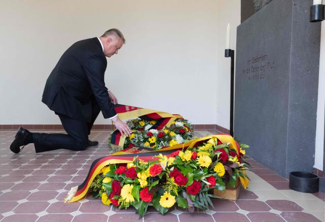 The State Premier of Rhineland-Palatinate Gordon Schnieder lays a wreath on July 14, 2026 at the cemetery chapel in Ahrweiler, western Germany, to commemorate the victims of the dramatic floods from July 2021. More than 180 people lost their lives five years ago in severe floods that pummelled western Germany in mid-July 2021, raising questions about whether enough was done to forewarn residents. (Photo by Boris Roessler / POOL / AFP)
