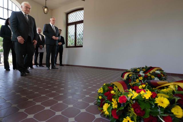 German President Frank-Walter Steinmeier (L) and the State Premier of Rhineland-Palatinate Gordon Schnieder (R) lay a wreath on July 14, 2026 at the cemetery chapel in Ahrweiler, western Germany, to commemorate the victims of the dramatic floods from July 2021. More than 180 people lost their lives five years ago in severe floods that pummelled western Germany in mid-July 2021, raising questions about whether enough was done to forewarn residents. (Photo by Boris Roessler / POOL / AFP)
