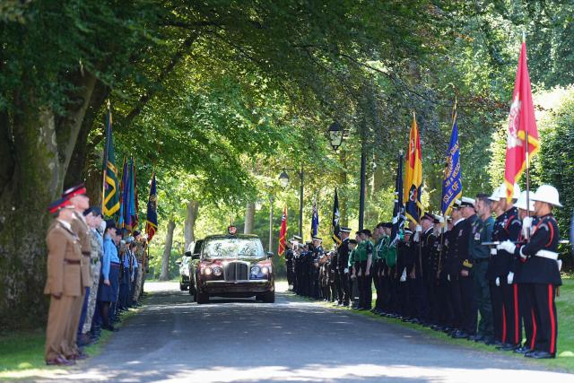 The car carrying Britain's King Charles III drives past a guard of honour as he arrives to attend a garden party for the Manx community in the grounds of Government House in Onchan on the Isle of Man, an island in the Irish Sea off of the west coast England, on July 14, 2026. (Photo by Aaron Chown / POOL / AFP)