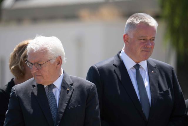 Rhineland-Palatinate's State Premier Gordon Schnieder (R) and German President Frank-Walter Steinmeier attend on July 14, 2026 a ceremony including a wreath-laying at the cemetery in Ahrweiler, western Germany, to commemorate the victims of the dramatic floods from July 2021. More than 180 people lost their lives five years ago in severe floods that pummelled western Germany in mid-July 2021, raising questions about whether enough was done to forewarn residents. (Photo by Boris Roessler / POOL / AFP)