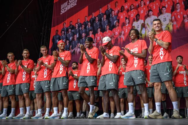 (From L) Switzerland's players defender #02 Miro Muheim, defender #03 Silvan Widmer, defender #04 Nico Elvedi, defender #05 Manuel Akanji, forward #07 Breel Embolo, midfielder #09 Johan Manzambi, midfielder #06 Denis Zakaria and midfielder #10 Granit Xhaka applaud  during a fan reception welcoming the team back to the country following its 2026 FIFA World Cup quarter-final match against Argentina, in Zurich on July 14, 2026. (Photo by Fabrice COFFRINI / AFP)