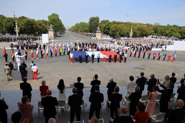 Heads of State and Government of the Coalition of the Willing applaud at the end of the annual Bastille Day military parade on the Place de la Concorde in Paris, France, July 14, 2026. (Photo by Ludovic MARIN / AFP)
