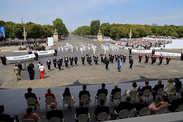 Heads of State and Government of the Coalition of the Willing watch as Musicians from the Marine Nationale (French Navy) Bagad de Lann-Bihoue (BAGAD) parade at the end of the annual Bastille Day military parade on the Place de la Concorde in Paris, France, July 14, 2026. (Photo by Ludovic MARIN / AFP)