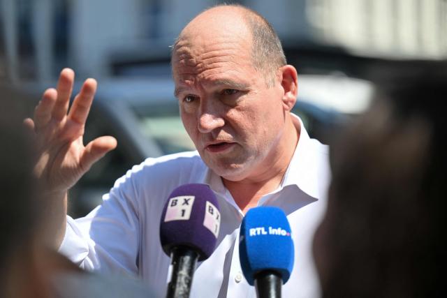 Bruxelles-Brussel mayor Philippe Close speaks to the press as he arrives at the scene of a fire at the OXY Tower housing complex in Brussels on July 14, 2026. The Brussels Labour Inspectorate said several bodies had been found in the building's lift shafts, while six people remained missing. The fire broke out on the second floor of the building, which was undergoing renovation. (Photo by EMILE WINDAL / Belga / AFP) / Belgium OUT