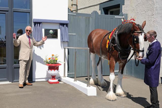 Britain's King Charles III (L) unveils a plaque to commemorate the 150th anniversary of the Douglas Horse Tramway along the promenade in Douglas on the Isle of Man, an island in the Irish Sea off of the west coast England, on July 14, 2026. (Photo by Chris Jackson / POOL / AFP)
