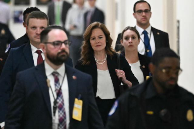 US Supreme Court Justice Amy Coney Barrett (C) arrives to testify during a House Appropriations Subcommittee on Financial Services hearing on Capitol Hill in Washington, DC, on July 14, 2026. (Photo by Kent NISHIMURA / AFP)
