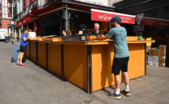 Employees set up a bar ahead of the opening of the Bayonne Festival, in Bayonne, south-western France, on July 14, 2026. The Bayonne Festival runs from July 15 to July 19, 2026. (Photo by Gaizka IROZ / AFP)