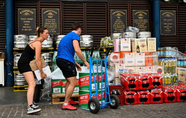 Employees deliver kegs of beer to a pub ahead of the opening of the Bayonne Festival, in Bayonne, south-western France, on July 14, 2026. The Bayonne Festival runs from July 15 to July 19, 2026. (Photo by Gaizka IROZ / AFP)
