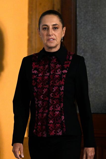Mexico's President Claudia Sheinbaum arrives for her daily press conference at Palacio Nacional in Mexico City on July 14, 2026. Homicides in Mexico have fallen by nearly half since September 2024, President Claudia Sheinbaum said, touting the reduction as a result of her security policies since taking office in October 2024. (Photo by Alfredo ESTRELLA / AFP)