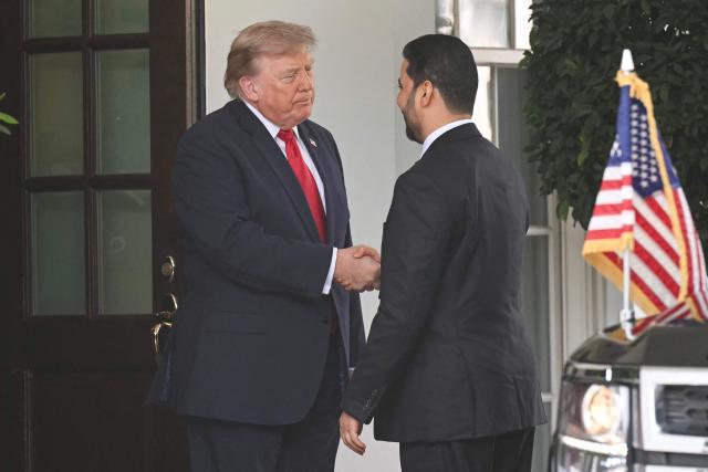 US President Donald Trump shakes hands with Prime Minister of Iraq Ali al-Zaidi (R) outside the West wing of the White House in Washington, DC, on July 14, 2026. (Photo by SAUL LOEB / AFP)