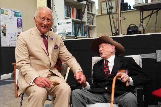 Britain's King Charles III (L) meets Burma veteran James Fenton, 104, at the charity 'Heroes On The Water Isle of Man', in Port Soderick on the Isle of Man, an island in the Irish Sea off of the west coast England, on July 14, 2026. 'Heroes On The Water Isle of Man' is a charity that supports military veterans, emergency service personnel and other uniformed public servants through kayak angling and outdoor activities. (Photo by Aaron Chown / POOL / AFP)