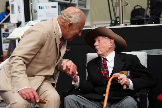 Britain's King Charles III (L) meets Burma veteran James Fenton, 104, at the charity 'Heroes On The Water Isle of Man', in Port Soderick on the Isle of Man, an island in the Irish Sea off of the west coast England, on July 14, 2026. 'Heroes On The Water Isle of Man' is a charity that supports military veterans, emergency service personnel and other uniformed public servants through kayak angling and outdoor activities. (Photo by Aaron Chown / POOL / AFP)