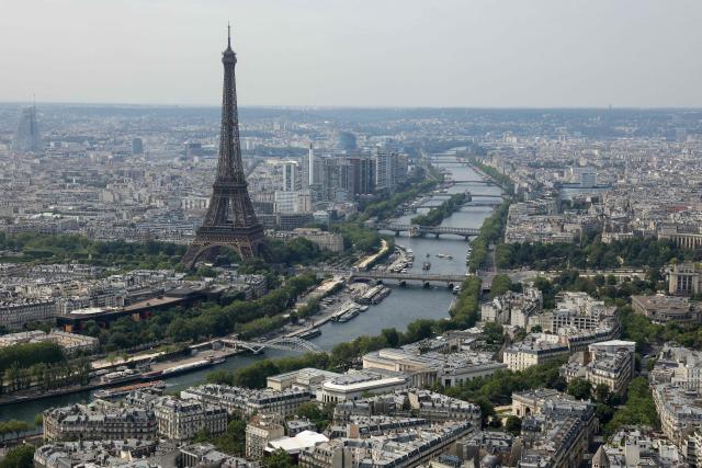 This aerial photograph taken on July 14, 2026, shows the Eiffel Tower and the river Seine in Paris. (Photo by Thomas SAMSON / AFP)