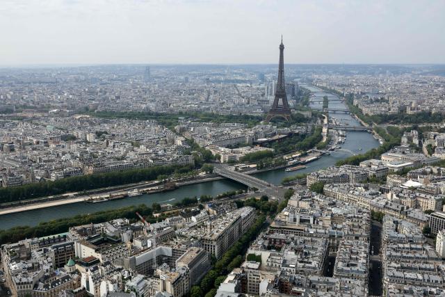 This aerial photograph taken on July 14, 2026, shows the Eiffel Tower and the river Seine in Paris. (Photo by Thomas SAMSON / AFP)