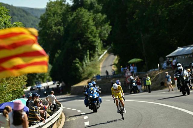UAE Team Emirates - XRG's Slovenian rider Tadej Pogacar wearing the overall leader's yellow jersey cycles in a breakaway in the final kilometers of the 10th stage of the 113th edition of the Tour de France cycling race, 166,6 km between Aurillac and Le Lioran in the Massif Central, on July 14, 2026. (Photo by Loic VENANCE / AFP)