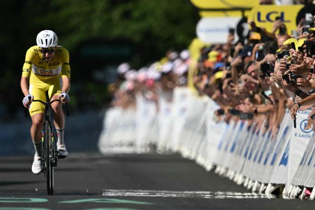UAE Team Emirates - XRG's Slovenian rider Tadej Pogacar cycles to the finish line to win the 10th stage of the 113th edition of the Tour de France cycling race, 166,6 km between Aurillac and Le Lioran in the Massif Central, on July 14, 2026. (Photo by Jeff PACHOUD / AFP)