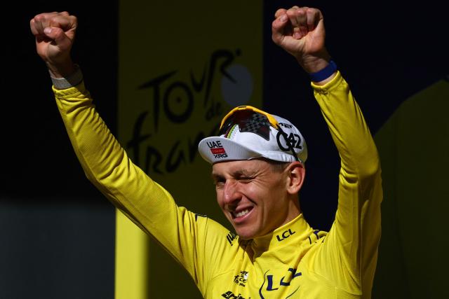 UAE Team Emirates - XRG's Slovenian rider Tadej Pogacar celebrates on the podium with the overall leader's yellow jersey after the 10th stage of the 113th edition of the Tour de France cycling race, 166,6 km between Aurillac and Le Lioran in the Massif Central, on July 14, 2026. (Photo by Anne-Christine POUJOULAT / AFP)