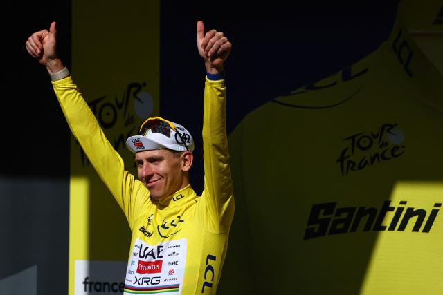 UAE Team Emirates - XRG's Slovenian rider Tadej Pogacar celebrates on the podium with the overall leader's yellow jersey after the 10th stage of the 113th edition of the Tour de France cycling race, 166,6 km between Aurillac and Le Lioran in the Massif Central, on July 14, 2026. (Photo by Anne-Christine POUJOULAT / AFP)