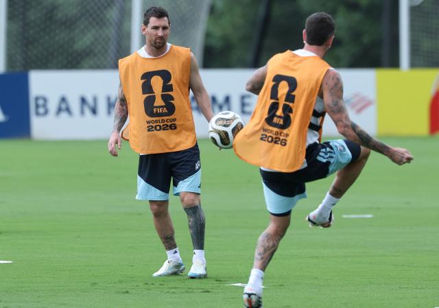 Argentina's forward #10 Lionel Messi and midfielder #07 Rodrigo De Paul play with a ball during a training session on the eve of the 2026 World Cup football tournament semi-final match between England and Argentina, at Atlanta United Training Centre in Atlanta on July 14, 2026.  (Photo by Thomas COEX / AFP)