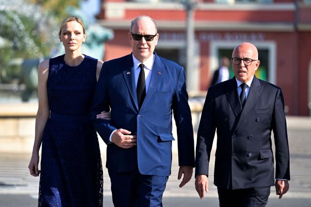 (From L) Princess Charlene of Monaco, Prince's Albert II of Monaco and Mayor of Nice Eric Ciotti arrive for a ceremony marking the 10th anniversary of an attack that killed 86 people and injured more than 400 in Nice, on the French riviera city of Nice on July 14, 2026. A solemn march, an interfaith ceremony, a military parade and a memorial service presided over by French President are on the programme for the commemorations marking the 10th anniversary of the attack on the Promenade des Anglais in Nice, as announced by the city council on July 1, 2026. On July 14, 2016, Mohamed Lahouaiej-Bouhlel, a Tunisian national, drove a 19-tonne lorry for nearly 2 km into the crowd that had just been watching the fireworks, killing 86 people and injuring more than 400 before he was shot dead. (Photo by Philippe Magoni / POOL / AFP)