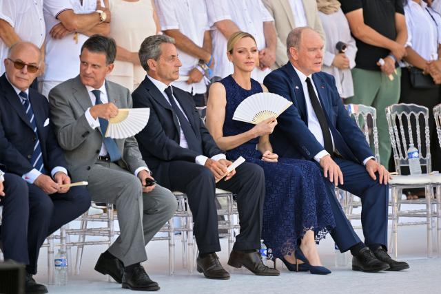 (From L) Former French Prime Minister Bernard Cazeneuve, former French prime minister Manuel Vals, former French President Nicolas Sarkozy, Princess Charlene of Monaco and Prince's Albert II of Monaco attend a ceremony marking the 10th anniversary of an attack that killed 86 people and injured more than 400 in Nice, on the French riviera city of Nice on July 14, 2026. A solemn march, an interfaith ceremony, a military parade and a memorial service presided over by French President are on the programme for the commemorations marking the 10th anniversary of the attack on the Promenade des Anglais in Nice, as announced by the city council on July 1, 2026. On July 14, 2016, Mohamed Lahouaiej-Bouhlel, a Tunisian national, drove a 19-tonne lorry for nearly 2 km into the crowd that had just been watching the fireworks, killing 86 people and injuring more than 400 before he was shot dead. (Photo by Philippe Magoni / POOL / AFP)