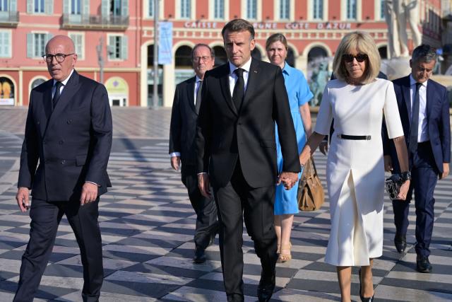(From L in front) Mayor of Nice Mayor Eric Ciotti, France's President Emmanuel Macron, his wife Brigitte Macron, (from L behind) former French French President Francois Hollande, President of the French National Assembly Yael Braun-Pivet and France's Justice Minister Gerald Darmanin arrive to attend a ceremony marking the 10th anniversary of an attack that killed 86 people and injured more than 400 in Nice, on the French riviera city of Nice on July 14, 2026. A solemn march, an interfaith ceremony, a military parade and a memorial service presided over by French President are on the programme for the commemorations marking the 10th anniversary of the attack on the Promenade des Anglais in Nice, as announced by the city council on July 1, 2026. On July 14, 2016, Mohamed Lahouaiej-Bouhlel, a Tunisian national, drove a 19-tonne lorry for nearly 2 km into the crowd that had just been watching the fireworks, killing 86 people and injuring more than 400 before he was shot dead. (Photo by Philippe Magoni / POOL / AFP)