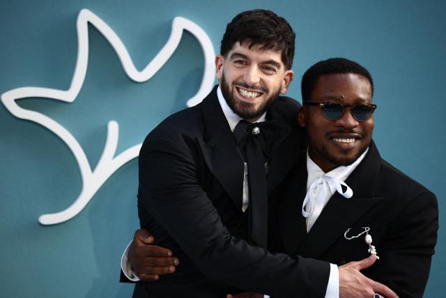 Actor Nima Taleghani (L) and English actor Fisayo Akinade react as they arrive on the red carpet for the world premiere of the film "Heartstopper Forever" in central London on July 14, 2026. (Photo by Henry NICHOLLS / AFP)