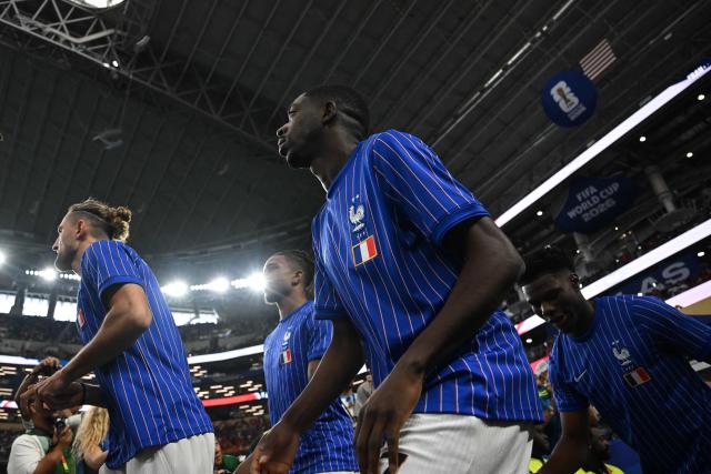 France's forward #07 Ousmane Dembele (2nd-R) and France's midfielder #08 Aurelien Tchouameni (R) arrive for the warmups before the start of the 2026 World Cup football tournament semi-final match between France and Spain at the Dallas Stadium in Arlington on July 14, 2026. (Photo by Paul ELLIS / AFP)