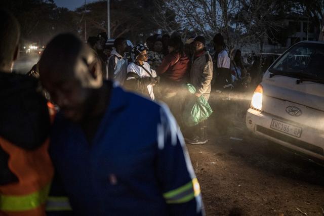 Malawian migrants gather in front of their Consulate in Johannesburg, on July 14, 2026 ahead of their repatriation towards Malawi. Several thousands more foreign nationals clamoured to leave South Africa on July 3, after a push that has already seen around 35,000 go home. The exodus began weeks ago as fringe groups began demanding all illegal migrants leave by June 30, in a campaign that saw violent protests and clashes. (Photo by MARCO LONGARI / AFP)