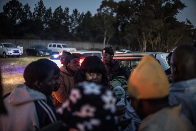 Malawian migrants gather in front of their Consulate in Johannesburg, on July 14, 2026 ahead of their repatriation towards Malawi. Several thousands more foreign nationals clamoured to leave South Africa on July 3, after a push that has already seen around 35,000 go home. The exodus began weeks ago as fringe groups began demanding all illegal migrants leave by June 30, in a campaign that saw violent protests and clashes. (Photo by MARCO LONGARI / AFP)