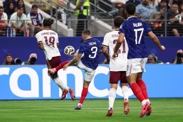 Spain's forward #19 Lamine Yamal is fouled by France's defender #03 Lucas Digne for a penalty kick during the 2026 World Cup football tournament semi-final match between France and Spain at the Dallas Stadium in Arlington on July 14, 2026.  (Photo by FRANCK FIFE / AFP)