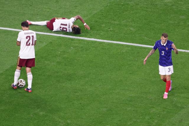 Spain's forward #19 Lamine Yamal (C) lies on the ground after being fouled by France's defender #03 Lucas Digne (R) and winning a penalty during the 2026 World Cup football tournament semi-final match between France and Spain at the Dallas Stadium in Arlington on July 14, 2026.  (Photo by Aric Becker / AFP)
