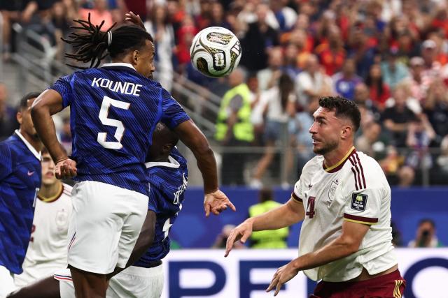 France's defender #05 Jules Kounde heads the ball past Spain's defender #14 Aymeric Laporte during the 2026 World Cup football tournament semi-final match between France and Spain at the Dallas Stadium in Arlington on July 14, 2026.  (Photo by FRANCK FIFE / AFP)