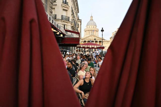 Supporters of France's football team watch the 2026 World Cup semi final football match between France and Spain at a cafe near the Pantheon (seen in background) in Paris on July 14, 2026. (Photo by Martin LELIEVRE / AFP)