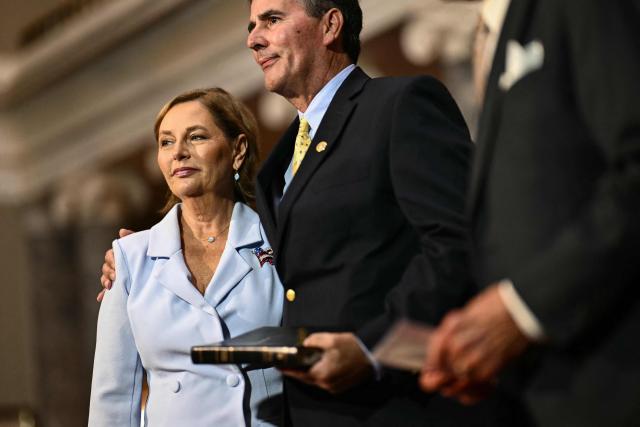 Darline Graham Nordone (L), sister of Lindsey Graham, is embraced by her husband Larry Nordone after being ceremonially sworn in as a US Senator by Senator Charles Grassley (R), Republican from Iowa, in the Old Senate Chamber at the US Capitol in Washington, DC, on July 14, 2026. South Carolina Governor Henry McMaster on July 13 appointed the late Republican senator Lindsey Graham's younger sister to complete his term, hours after President Donald Trump publicly urged him to choose her. Darline Graham Nordone will serve in the US Senate until Graham's term expires in January, following his unexpected death at the weekend at the age of 71. (Photo by Kent NISHIMURA / AFP)