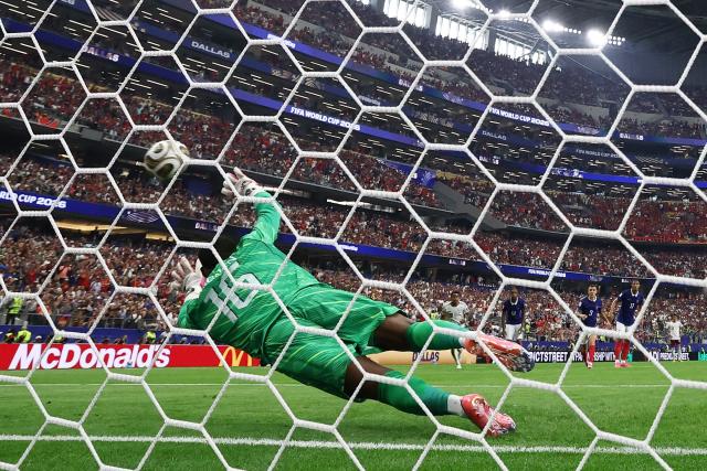 France's goalkeeper #16 Mike Maignan concedes a penalty kick scored by Spain's forward #21 Mikel Oyarzabal (out of frame) and his team's first goal during the 2026 World Cup football tournament semi-final match between France and Spain at the Dallas Stadium in Arlington on July 14, 2026.  (Photo by FRANCK FIFE / AFP)
