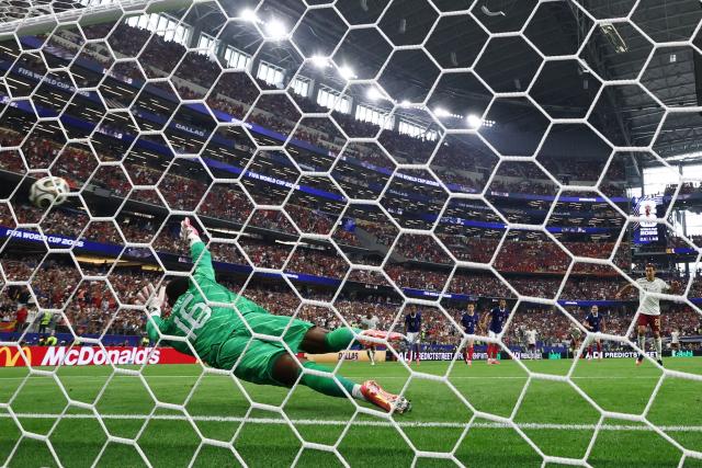 France's goalkeeper #16 Mike Maignan concedes a penalty kick scored by Spain's forward #21 Mikel Oyarzabal and his team's first goal during the 2026 World Cup football tournament semi-final match between France and Spain at the Dallas Stadium in Arlington on July 14, 2026.  (Photo by FRANCK FIFE / AFP)