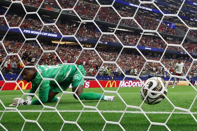 France's goalkeeper #16 Mike Maignan concedes a penalty kick scored by Spain's forward #21 Mikel Oyarzabal (out of frame) and his team's first goal during the 2026 World Cup football tournament semi-final match between France and Spain at the Dallas Stadium in Arlington on July 14, 2026.  (Photo by FRANCK FIFE / AFP)