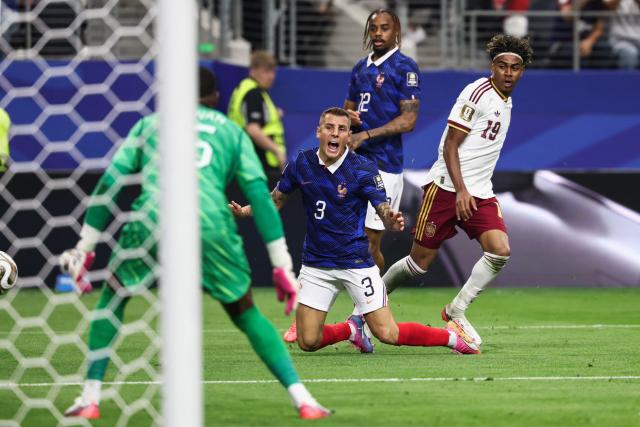 France's defender #03 Lucas Digne falls past Spain's forward #19 Lamine Yamal during the 2026 World Cup football tournament semi-final match between France and Spain at the Dallas Stadium in Arlington on July 14, 2026.  (Photo by FRANCK FIFE / AFP)