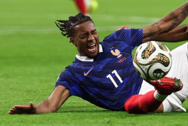 France's forward #11 Michael Olise falls on the field fighting for the ball during the 2026 World Cup football tournament semi-final match between France and Spain at the Dallas Stadium in Arlington on July 14, 2026.  (Photo by FRANCK FIFE / AFP)